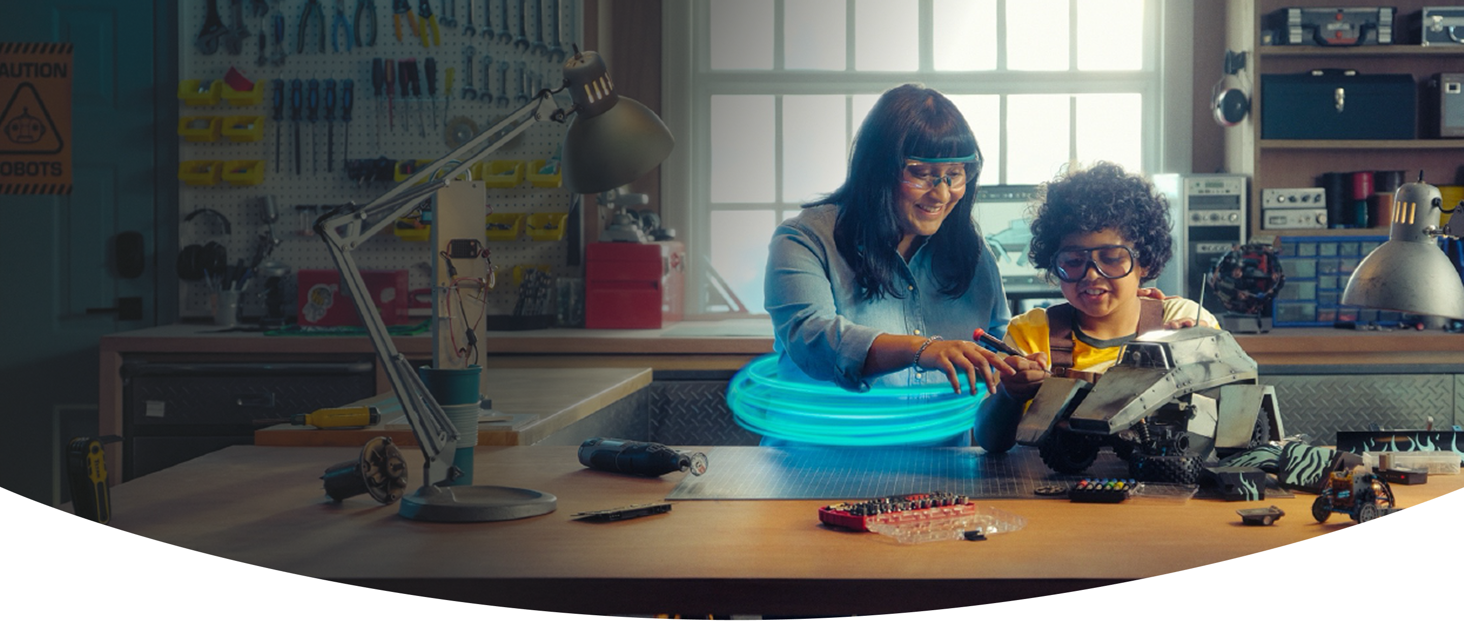 A woman and a young boy working together on a remote-controlled vehicle