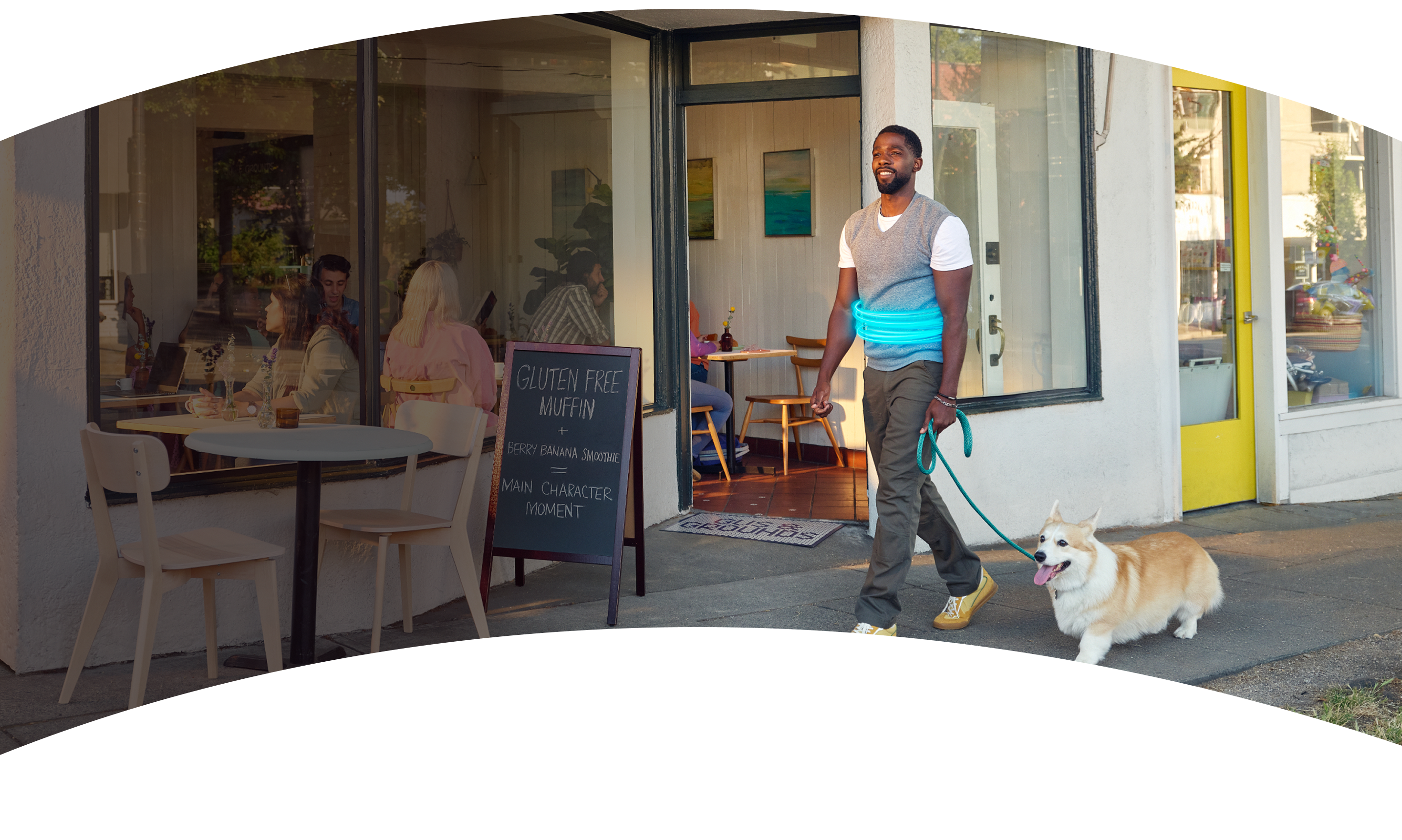 A man walking his dog on a sidewalk
