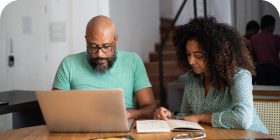 Man and woman working on laptop