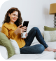 Woman drinking coffee using her smartphone