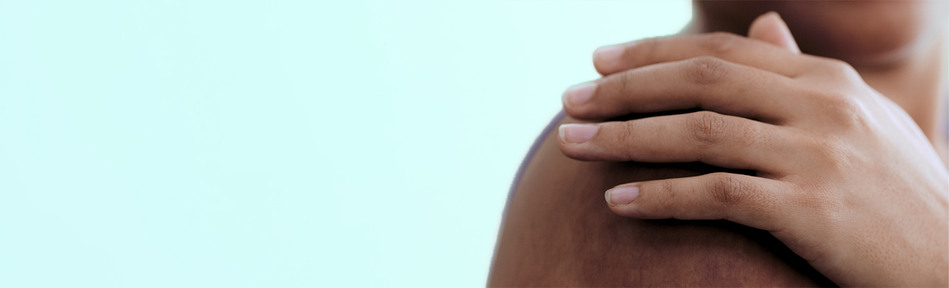 A person's hand on their shoulder