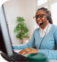 Woman in blue sweater smiling while talking into a headset