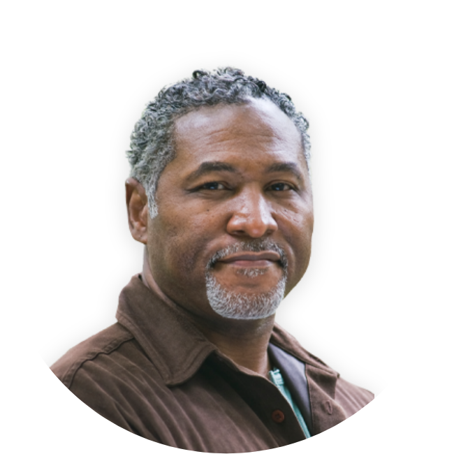 Man in a brown collared shirt looking ahead
