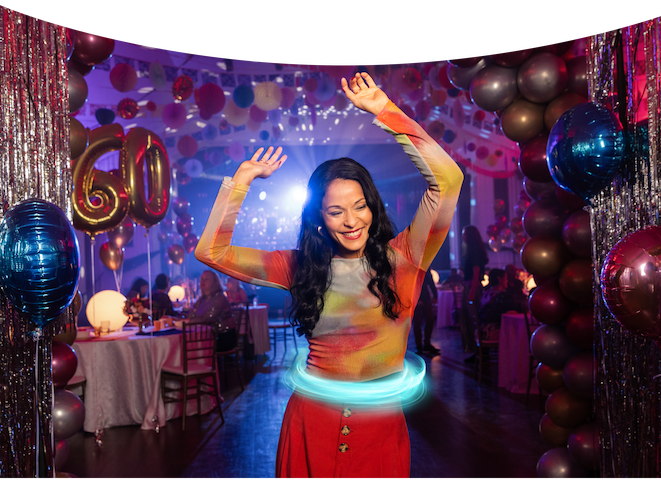 Woman dancing at a party with her hands in the air